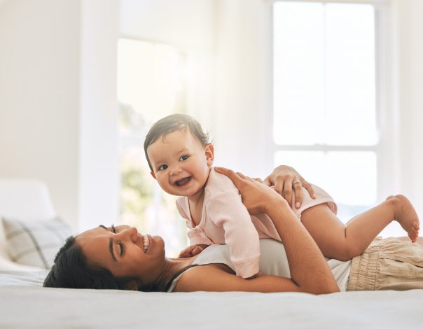 Cropped shot of an attractive young woman and her newborn baby at home